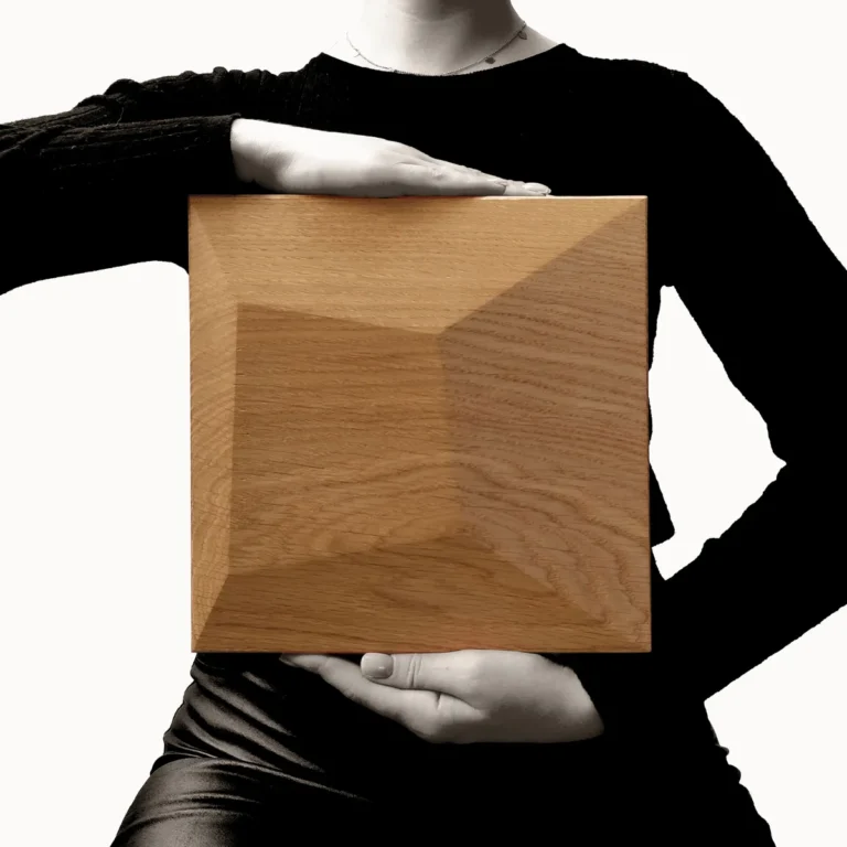 Single wooden wall panel held by model in black clothing